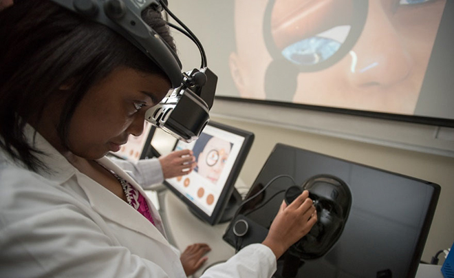 student working with a piece of scientific equipment