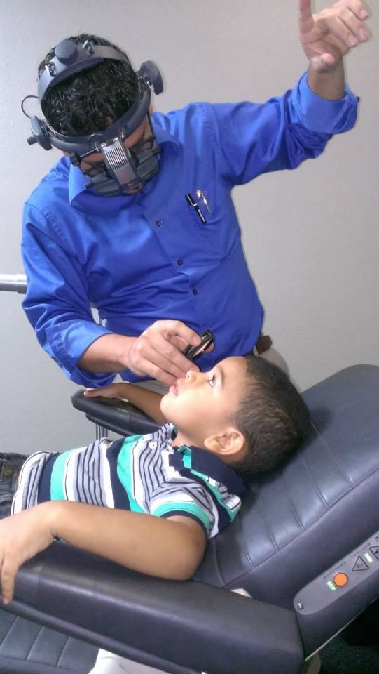Dr. Jose Correa working with a child patient